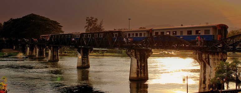 Evening local train crossing the Bridge on the River Kwai